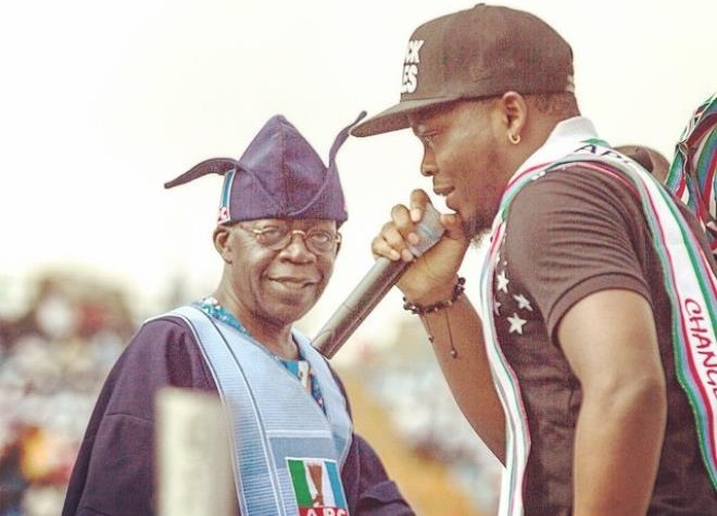 Shocking: See How Gov. Fashola Stares at Olamide’s New Born Baby